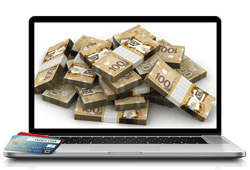 ordinateur avec cartes bancaires et billets CAD